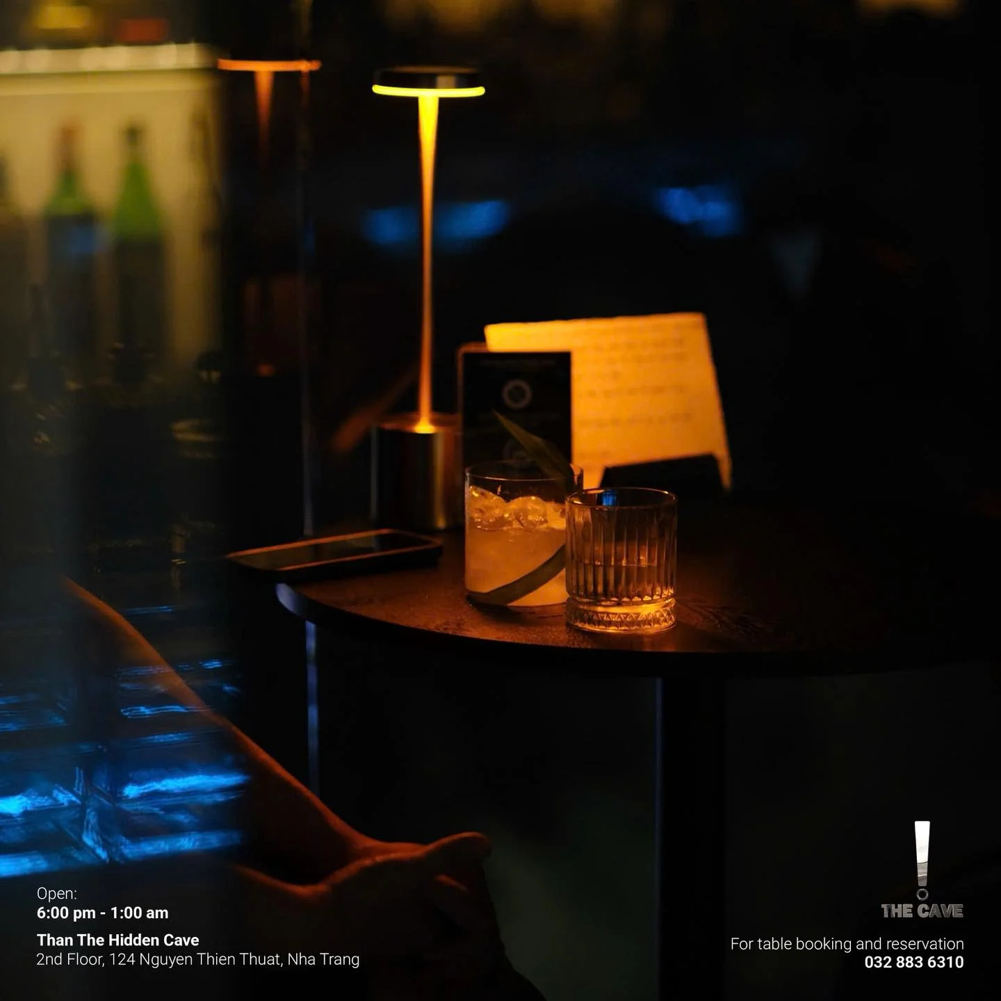 Two drinks under a warm table lamp